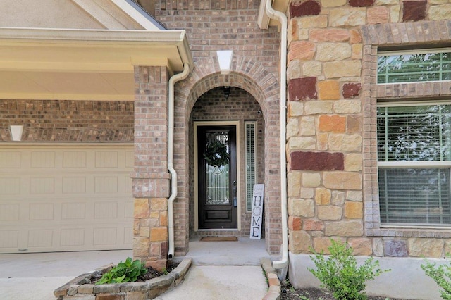 109 Lake Livingston Dr, Georgetown, TX 78628 - view of exterior entry featuring stone siding, brick siding, and a garage