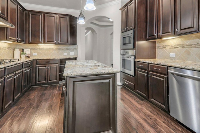 109 Lake Livingston Dr, Georgetown, TX 78628 - kitchen featuring appliances with stainless steel finishes, arched walkways, crown molding, dark wood-style flooring, and light stone counters