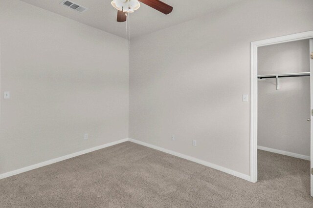 109 Lake Livingston Dr, Georgetown, TX 78628 - unfurnished bedroom with carpet, a walk in closet, a closet, and a ceiling fan