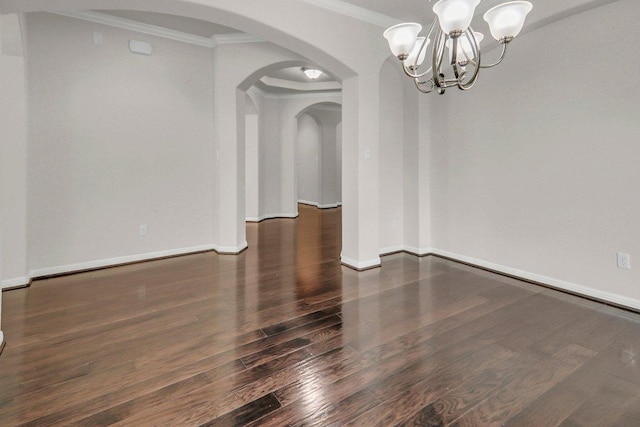 109 Lake Livingston Dr, Georgetown, TX 78628 - spare room with crown molding, a chandelier, arched walkways, and wood finished floors