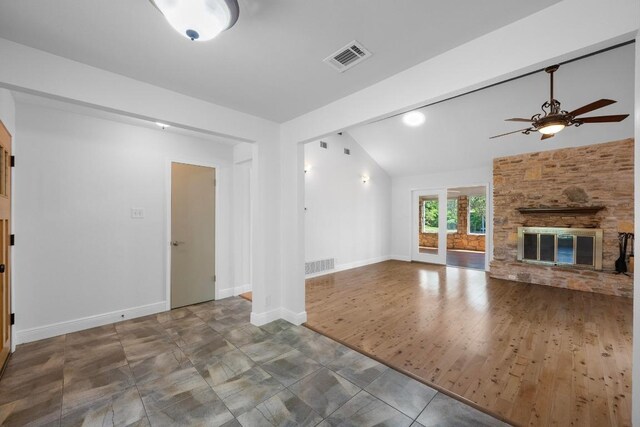 8006 Red Willow Dr, Austin, TX 78736 - unfurnished living room featuring ceiling fan, lofted ceiling, and a stone fireplace