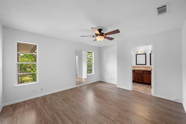 8006 Red Willow Dr, Austin, TX 78736 - unfurnished bedroom featuring light wood-style flooring, ensuite bath, and a ceiling fan