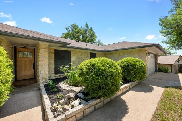 8006 Red Willow Dr, Austin, TX 78736 - view of front of property with stone siding, driveway, and an attached garage