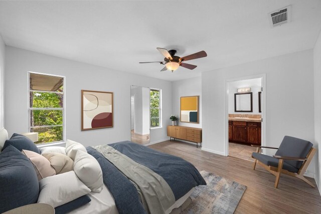 8006 Red Willow Dr, Austin, TX 78736 - bedroom with light wood finished floors, ceiling fan, and ensuite bathroom