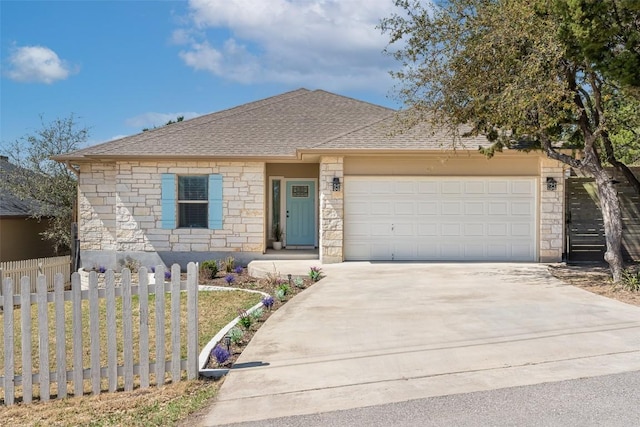 17219 Oak Cliff Cir, Dripping Springs, TX 78620 - view of front of home featuring concrete driveway, stone siding, fence, an attached garage, and a shingled roof