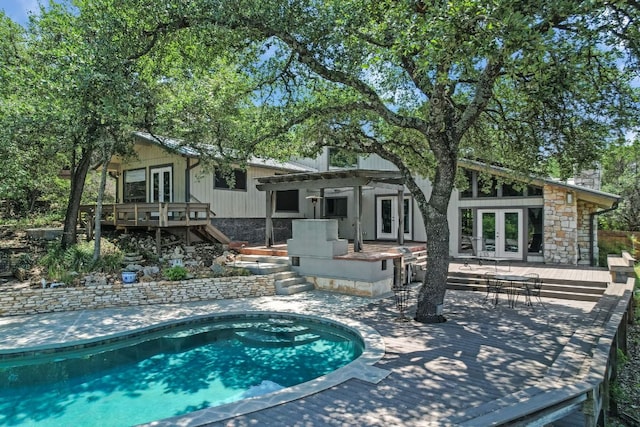 1004 Castle Ridge Rd, Austin, TX 78746 - swimming pool featuring french doors, a wooden deck, stairs, and a patio area