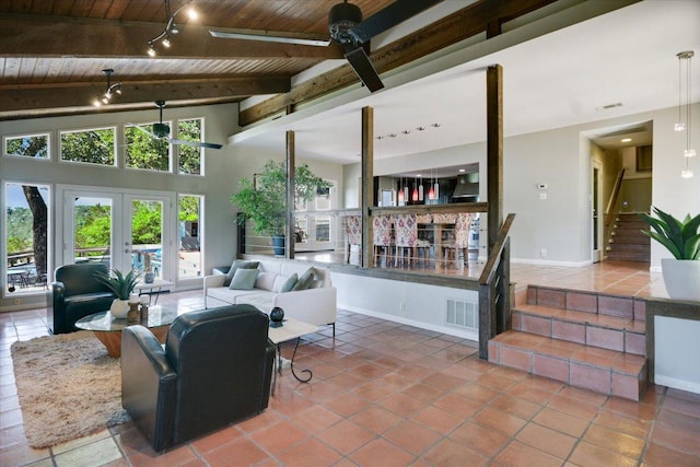 1004 Castle Ridge Rd, Austin, TX 78746 - tiled living room with wooden ceiling, ceiling fan, stairway, beam ceiling, and french doors