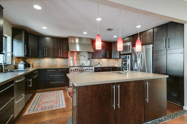 1004 Castle Ridge Rd, Austin, TX 78746 - kitchen with wall chimney exhaust hood, appliances with stainless steel finishes, a sink, light countertops, and decorative backsplash