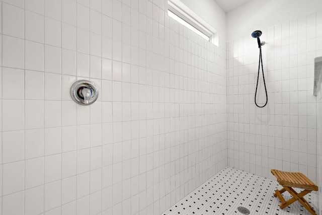 full bath featuring a tile shower