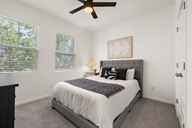 bedroom with carpet flooring, baseboards, and a ceiling fan