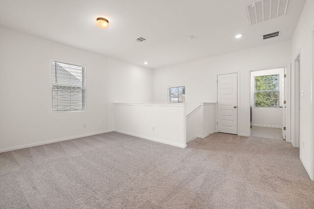 unfurnished room featuring carpet flooring, plenty of natural light, recessed lighting, and baseboards