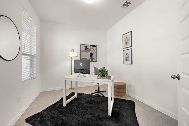 office area with light tile patterned floors and baseboards