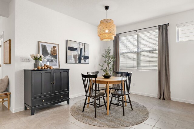 dining space featuring light tile patterned floors and baseboards