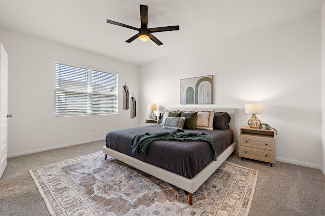 carpeted bedroom featuring baseboards and ceiling fan
