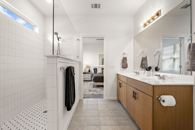 bathroom featuring a walk in shower, plenty of natural light, double vanity, and ensuite bathroom