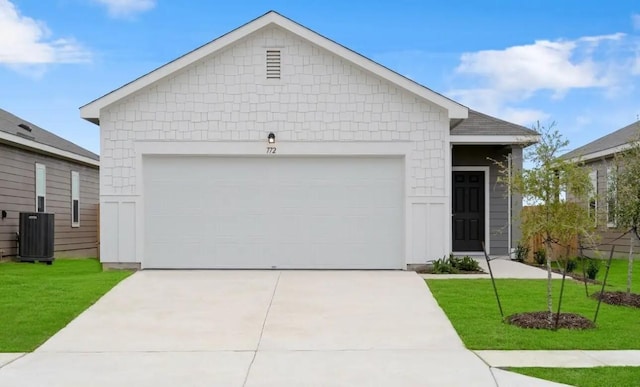 single story home featuring central AC, a front lawn, concrete driveway, and a garage