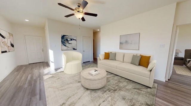 living area with wood finished floors, ceiling fan, and recessed lighting