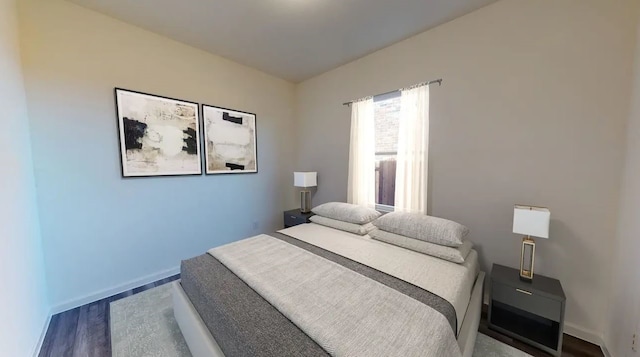 bedroom featuring wood finished floors and baseboards