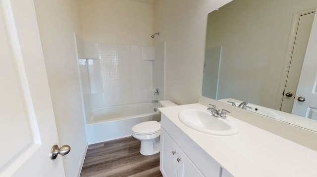 full bath featuring wood finished floors, toilet, vanity, and shower / tub combination