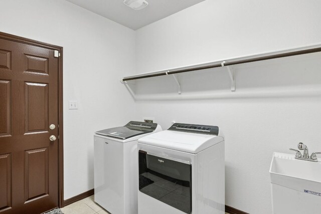 221 Mandana St, Leander, TX 78641 - washroom with washing machine and dryer and light tile patterned floors