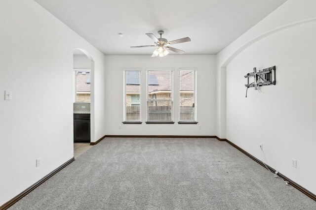 221 Mandana St, Leander, TX 78641 - spare room featuring arched walkways, ceiling fan, and light carpet