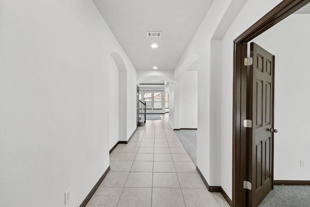 221 Mandana St, Leander, TX 78641 - hall with arched walkways, light tile patterned floors, and recessed lighting