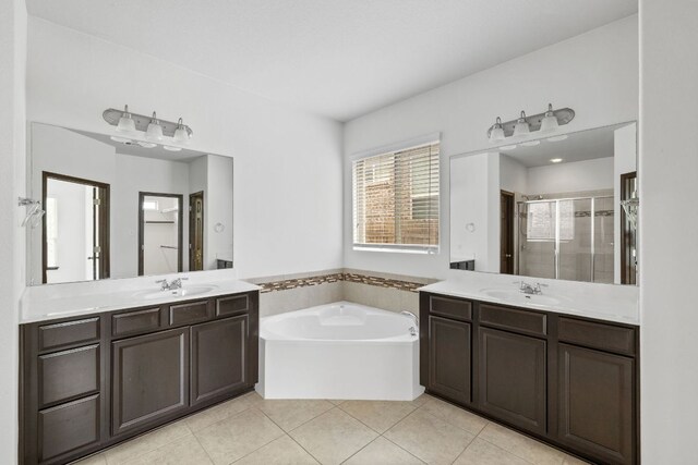 221 Mandana St, Leander, TX 78641 - full bath with a stall shower, two vanities, a garden tub, and tile patterned floors