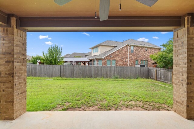 221 Mandana St, Leander, TX 78641 - fenced backyard with a ceiling fan and a patio