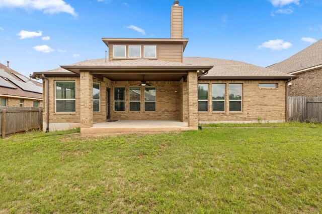 221 Mandana St, Leander, TX 78641 - rear view of house with ceiling fan, brick siding, a patio, a chimney, and a fenced backyard