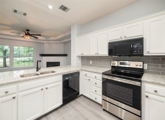 kitchen with black appliances, a sink, a ceiling fan, white cabinets, and recessed lighting