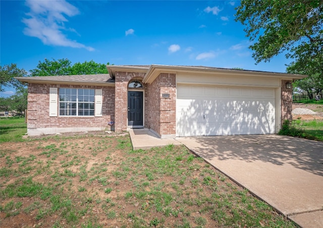 2312 Mac Arthur Ave, Lago Vista, TX 78645 - ranch-style house featuring brick siding, concrete driveway, and a garage