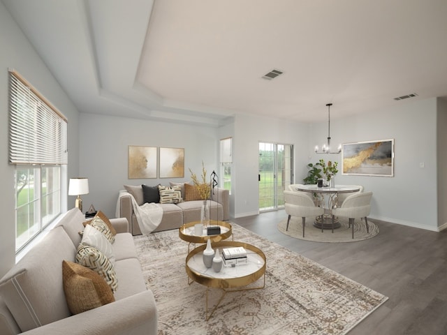 living room with a chandelier, baseboards, and dark wood-type flooring