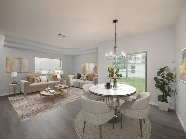 dining space featuring a chandelier, plenty of natural light, dark wood finished floors, and baseboards