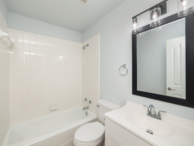 bathroom featuring washtub / shower combination, toilet, and vanity