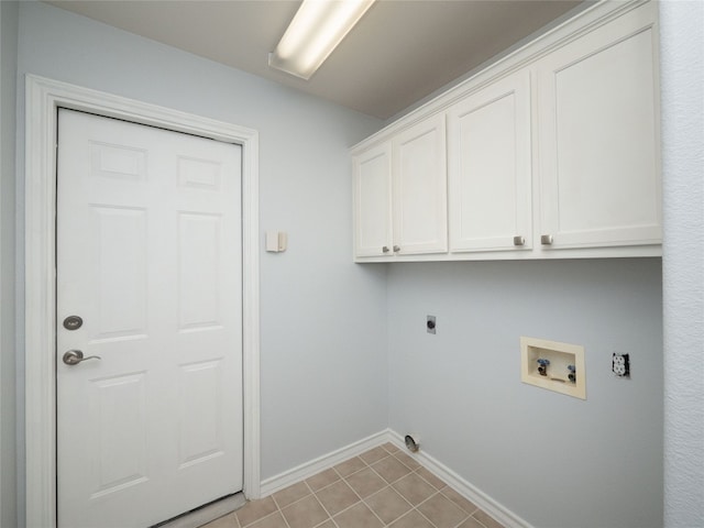 washroom with cabinet space, baseboards, hookup for a washing machine, and hookup for an electric dryer