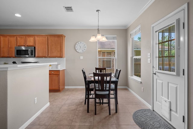 191 Fresno Spgs, Buda, TX 78610 - dining area featuring a chandelier, light tile patterned floors, crown molding, and baseboards