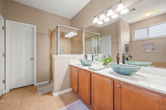 191 Fresno Spgs, Buda, TX 78610 - bathroom featuring a stall shower, double vanity, and tile patterned floors