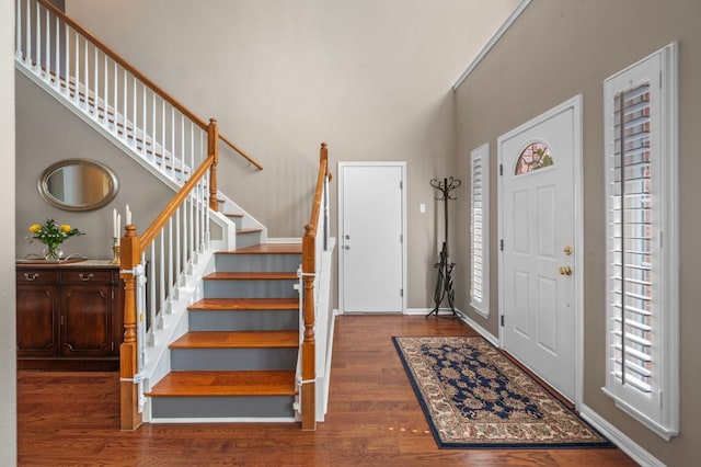 191 Fresno Spgs, Buda, TX 78610 - foyer with wood finished floors, stairway, a towering ceiling, and baseboards