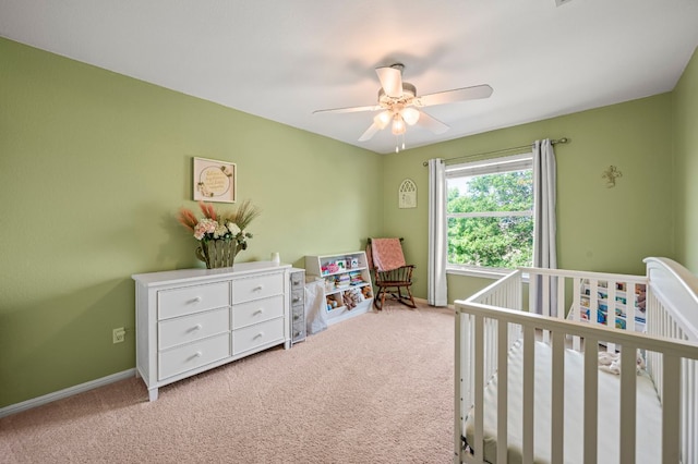 191 Fresno Spgs, Buda, TX 78610 - carpeted bedroom featuring a crib, baseboards, and ceiling fan