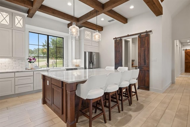 1278 Sanctuary Ln, Blanco, TX 78606 - kitchen featuring stainless steel fridge, a barn door, tasteful backsplash, coffered ceiling, and beam ceiling