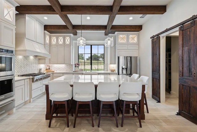 1278 Sanctuary Ln, Blanco, TX 78606 - kitchen featuring appliances with stainless steel finishes, a barn door, backsplash, coffered ceiling, and beam ceiling