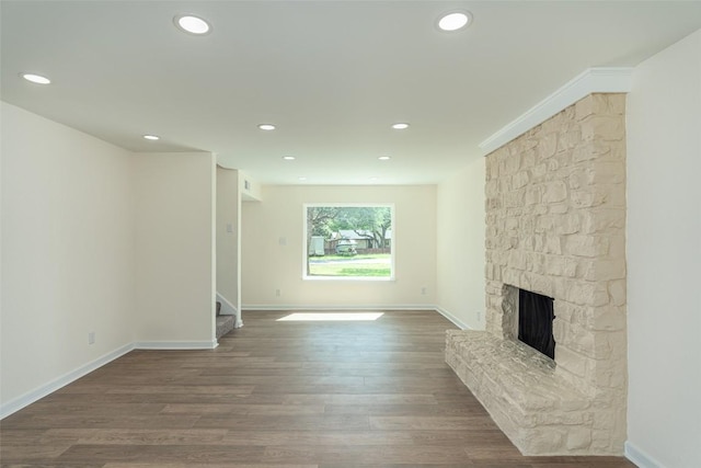 2105 Emerald Isle Dr, Leander, TX 78641 - unfurnished living room with stairs, recessed lighting, a fireplace, baseboards, and wood finished floors