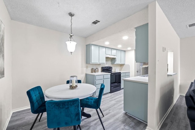8805 Clearbrook Trl Unit A, Austin, TX 78729 - dining area featuring light wood finished floors, a textured ceiling, and recessed lighting