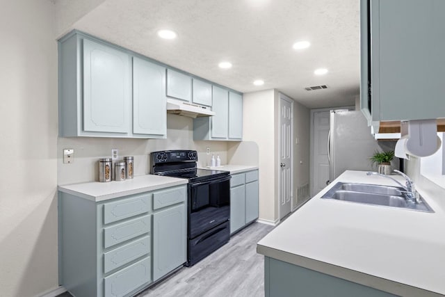 8805 Clearbrook Trl Unit A, Austin, TX 78729 - kitchen featuring electric range, under cabinet range hood, a sink, light wood finished floors, and recessed lighting