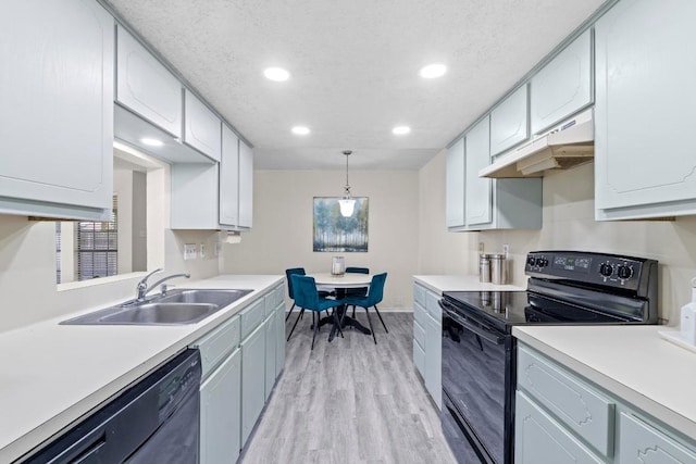 8805 Clearbrook Trl Unit A, Austin, TX 78729 - kitchen featuring black range with electric cooktop, under cabinet range hood, dishwashing machine, recessed lighting, and light countertops