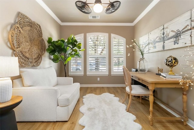 sitting room with wood finished floors, ornamental molding, a chandelier, and baseboards