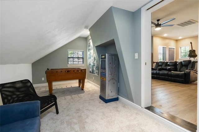 sitting room with ceiling fan, vaulted ceiling, baseboards, and carpet flooring