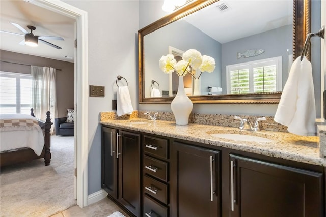 ensuite bathroom with a ceiling fan and double vanity