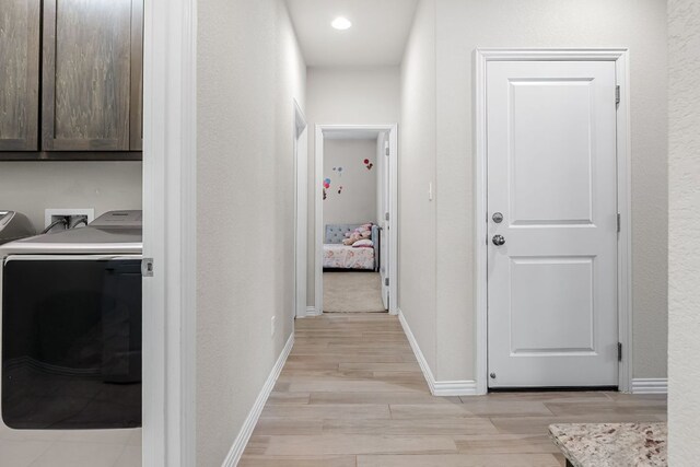 12709 Twisted Root Dr, Manchaca, TX 78652 - corridor featuring light wood-type flooring, washing machine and clothes dryer, and baseboards