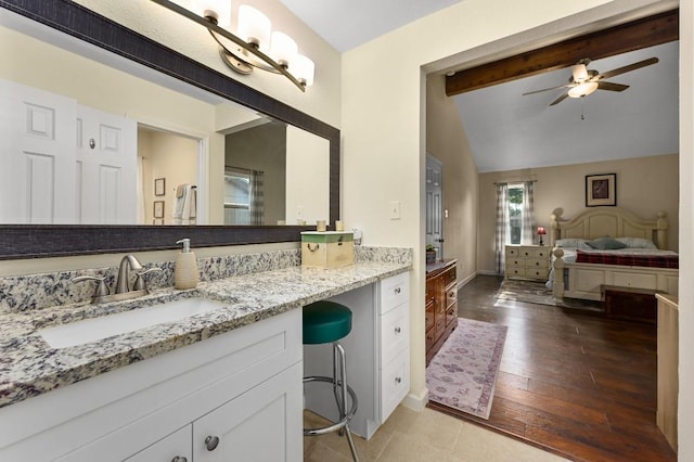 bathroom featuring a ceiling fan, baseboards, vanity, and wood finished floors